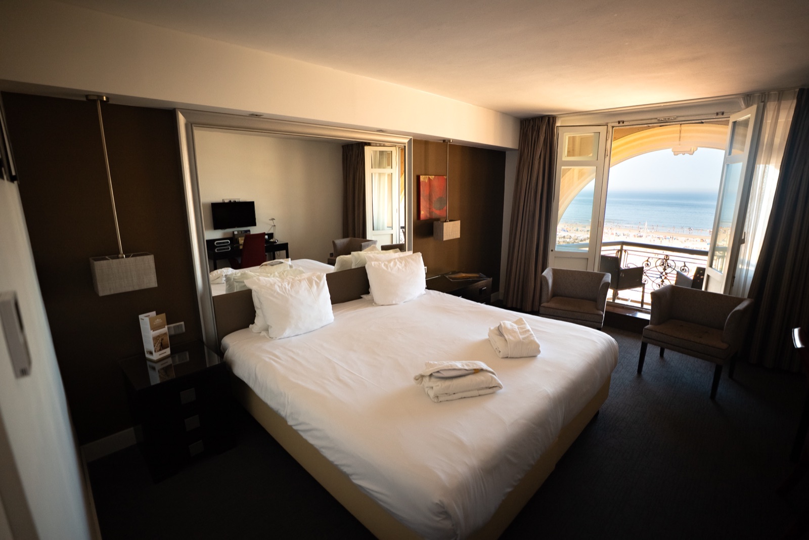 Kurhaus hotel room with the balcony doors open onto the beach and the North Sea
