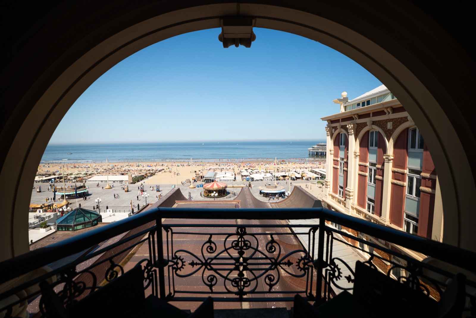 View from a Kurhaus arched loggia over the Scheveningen beach and pier